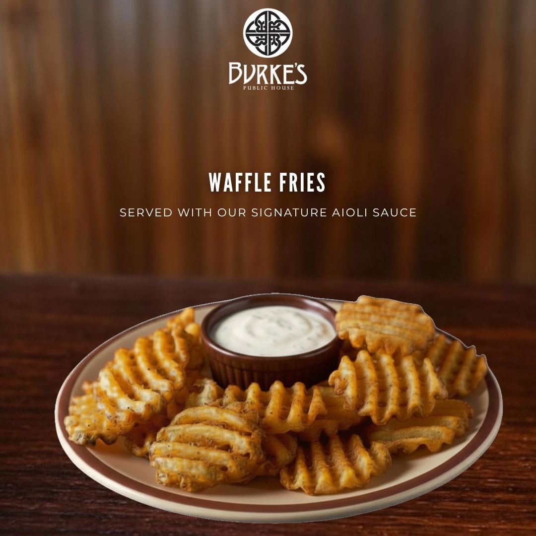 Crispy golden waffle fries served with Burke's signature aioli dipping sauce at Burke's Public House in Edgewater, Chicago